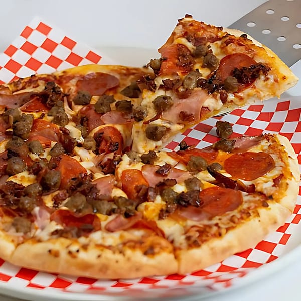 A slice of Pizza Time Pub's meat lover's pizza being lifted from the pie.