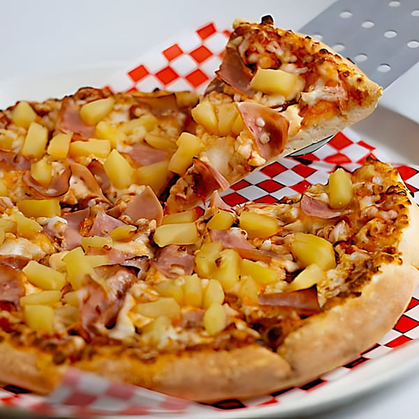 A slice of Pizza Time Pub's Hawaiian pizza, topped with ham and pineapple, being lifted.